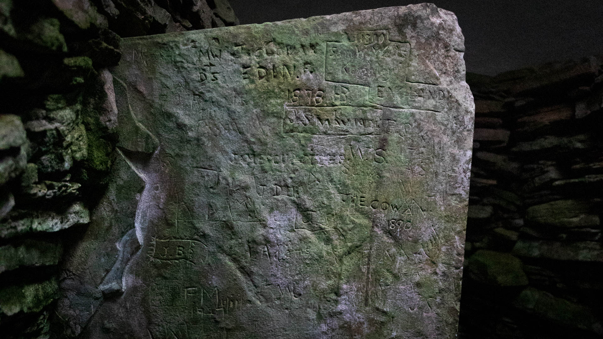 Inscriptions on a standing stone inside the Unstan Chambered Cairn.